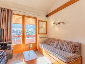 ein Wohnzimmer mit einem Sofa und einem Fenster in der Unterkunft Appartement Plagne Soleil, 3 pièces, 6 personnes - FR-1-351-3 in Plagne Villages