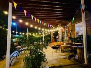 a patio at night with lights and flags at WIND HILL HOMESTAY HÀ GIANG in Làng Me