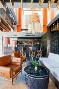 a lobby of a hotel with couches and a bar at Shinta Mani Mustang in Jomsom