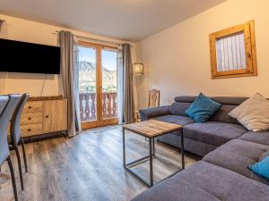 a living room with a couch and a tv at Chalet Plagne Soleil, 4 pièces, 8 personnes - FR-1-351-83 in Plagne Villages