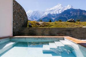 a swimming pool with mountains in the background at Shinta Mani Mustang in Jomsom