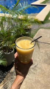 a person holding a cup with a drink at La Pang Resort 라팡리조트 in Panglao