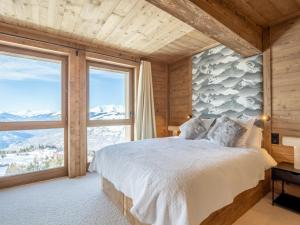 a bedroom with a bed and a large window at Appartement Les Arcs 1600, 5 pièces, 12 personnes - FR-1-461A-15 in Arc 1600
