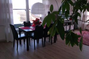 a dining room table with black chairs and a plant at Peaceful Stay/Heart of Gdansk/Unforgettable in Gdańsk +7 photos