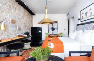 a hotel room with a bed and a table and chairs at Shinta Mani Mustang in Jomsom