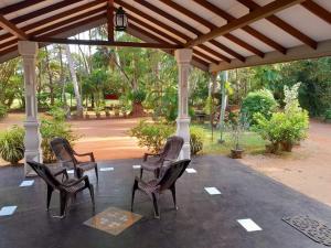 a group of chairs sitting on a patio at Sisila Guest House in Anuradhapura