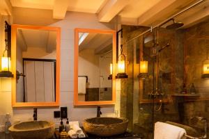 a bathroom with two sinks and a shower at Shinta Mani Mustang in Jomsom