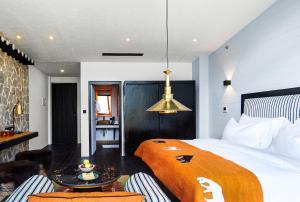 a bedroom with a bed and a table and chairs at Shinta Mani Mustang in Jomsom
