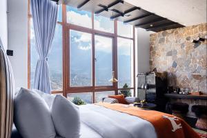 a bedroom with a large window and a large bed at Shinta Mani Mustang in Jomsom