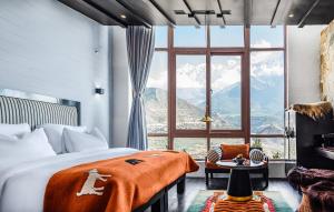 a bedroom with a large window with a view of mountains at Shinta Mani Mustang in Jomsom