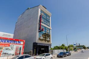 a tall building with cars parked in front of it at ACAR SMART OTEL in Arnavutköy