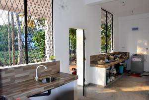 a kitchen with a sink and a window at Villa Weligama Gedara in Weligama
