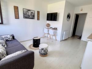 ein Wohnzimmer mit einem Sofa und einem Tisch in der Unterkunft Appartement Courseulles-sur-Mer, 2 pièces, 4 personnes - FR-1-746-15 in Courseulles-sur-Mer