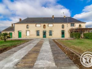 a large white house with green doors and a driveway at Gîte Beaupréau-en-Mauges-Beaupréau, 3 pièces, 5 personnes - FR-1-622-73 