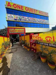 a guest house with potted plants in front of it at A ONE GUEST HOUSE in Tālcher