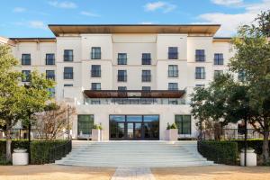 a large white building with a staircase in front at The Westin Dallas Stonebriar Golf Resort & Spa in Frisco