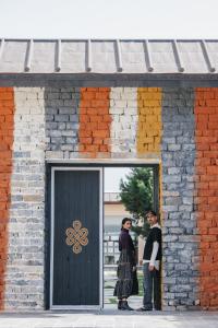 two people standing in front of a door at Shinta Mani Mustang in Jomsom