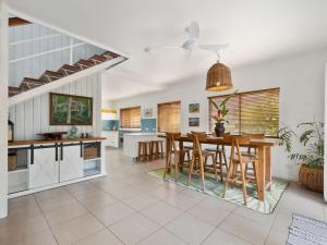 a kitchen and dining room with a table and chairs at Beach House on Pearl - Kingscliff Central in Kingscliff