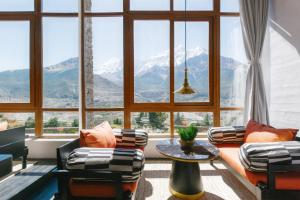 a living room with a large window with mountains at Shinta Mani Mustang in Jomsom