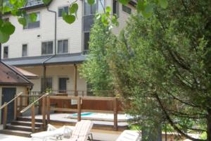 a patio with two lawn chairs and a building at Lulu City 6K by AvantStay Condo in Great Location Close to Skiing Downtown in Telluride