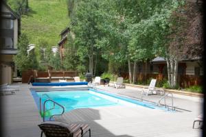 a large swimming pool with chairs at Lulu City 6K by AvantStay Condo in Great Location Close to Skiing Downtown in Telluride