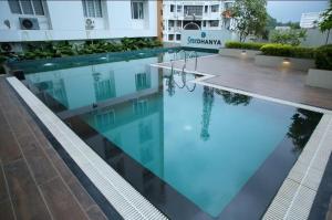 a pool with blue water in a building at Heaven vantage point in Trivandrum