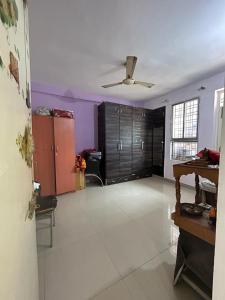 a living room with a ceiling fan and a room with cabinets at rajul flats adarsh nagar jabalpur in Jabalpur