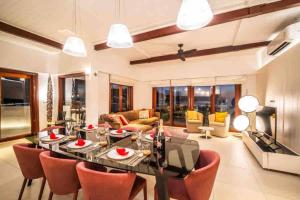 a living room with a dining table and chairs at Lang- Villa Amara，Kamala beach luxury villa in Surin Beach