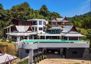 an aerial view of a house with a swimming pool at Lang- Villa Amara，Kamala beach luxury villa in Surin Beach