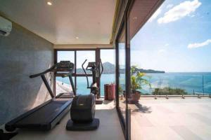 a house with a gym with a view of the ocean at Lang- Villa Amara，Kamala beach luxury villa in Surin Beach