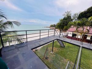 a balcony of a house with a view of the ocean at Seaview Mini Chalet - Direct Beach Access in Tanjung Bungah