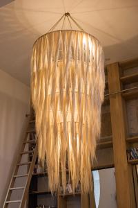 a chandelier with feathers hanging from a ceiling at Cuna del Cielo in San Miguel de Allende