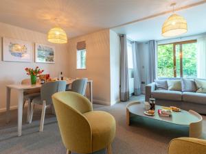 a living room with a couch and a table at 2 Bed in St. Mellion 87707 in St Mellion