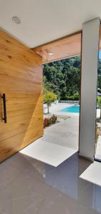 an open door with a view of a pool at TERRA LOMA House Hotel in Nimaima