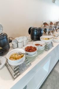 a buffet with bowls of food and pots and pans at Best Western Chatuchak in Bangkok