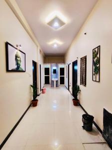 a hallway with potted plants in a building at DivineStay - Full Villa by AP Villas in Ujjain