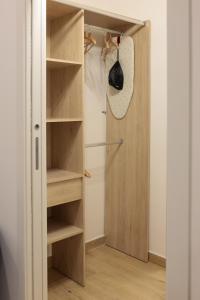 Armario con puerta de madera y estanterías en Sorelle Costa apartments en Caserta