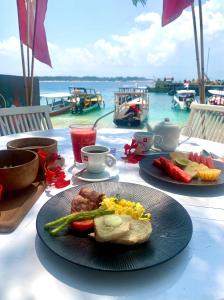 a table with two plates of food on it at Diversia Diving Club & Bungalows in Gili Trawangan