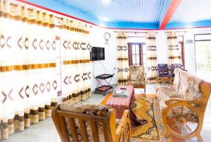 a living room with a couch and a tv at Adisham village home in Haputale