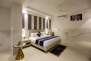 a bedroom with a king sized bed and a table at Hotel Delhi 37 by Star Group NEAR DELHI AIRPORT in New Delhi