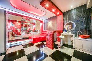 a bathroom with a red couch and a sink at Star Motel in Daegu