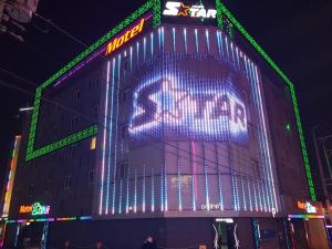 a building with a lit up sign on the side of it at Star Motel in Daegu