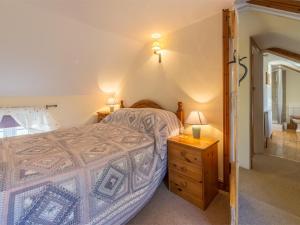 a bedroom with a bed and a wooden dresser at 3 Bed in Syderstone KT083 in Syderstone