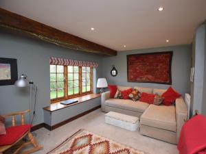 a living room with a couch and red pillows at 4 Bed in Icklesham BT067 in Icklesham