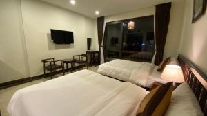Gulta vai gultas numurā naktsmītnē Dongvan Ville Du H'Mong Hotel