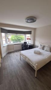 a bedroom with a large bed and a window at NEW! Brand New Beautiful Modern Apartment in London