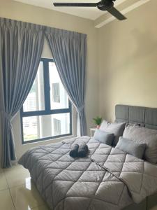 a bedroom with a large bed with a large window at DnQ Homestay at The Horizon with Netflix, LG Purifier,Wifi in the Centre of Ipoh in Ipoh