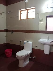 a bathroom with a toilet and a sink at Casa Branca Retreat in Varkala