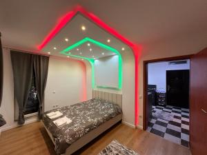 a bedroom with a bed with neon lights on it at 38 Apartment 2 in Pristina