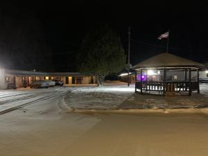 a bus stop in the snow at night at Tour Inn Motel in Howard City